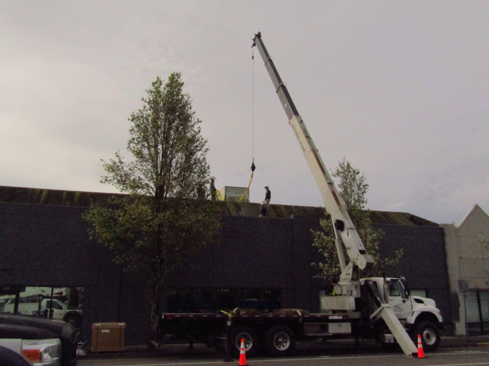 Crane lifting equipment onto a commercial rooftop